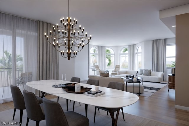 dining area with wood-type flooring and an inviting chandelier