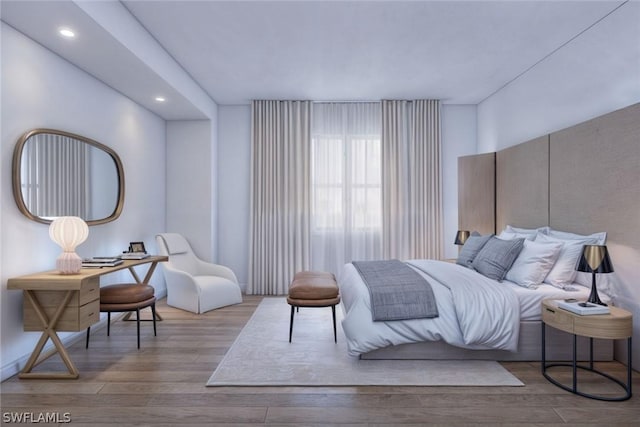 bedroom with recessed lighting and wood finished floors