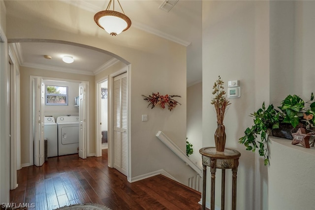 entryway with washer and dryer, crown molding, arched walkways, visible vents, and dark wood-style floors