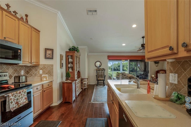 kitchen featuring crown molding, appliances with stainless steel finishes, a sink, light countertops, and visible vents