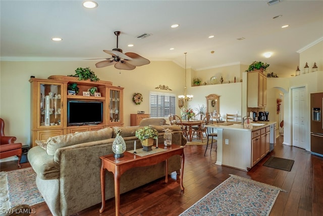 living area with visible vents, dark wood finished floors, high vaulted ceiling, ceiling fan with notable chandelier, and ornamental molding