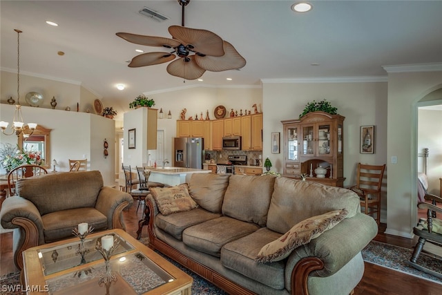 living room featuring lofted ceiling, ornamental molding, hardwood / wood-style flooring, and ceiling fan with notable chandelier