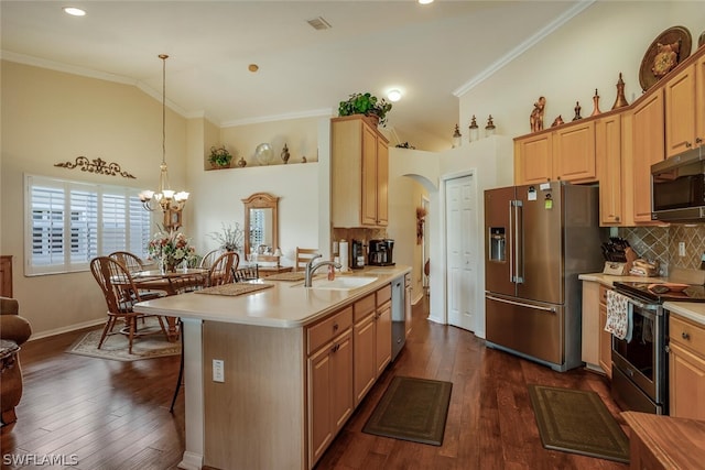 kitchen with decorative backsplash, a breakfast bar area, appliances with stainless steel finishes, arched walkways, and light countertops