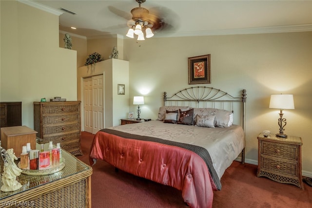 carpeted bedroom with ceiling fan, a closet, and crown molding