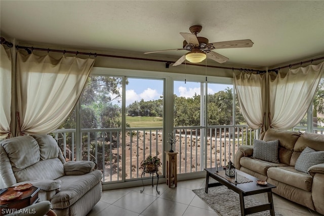 sunroom / solarium featuring plenty of natural light and ceiling fan