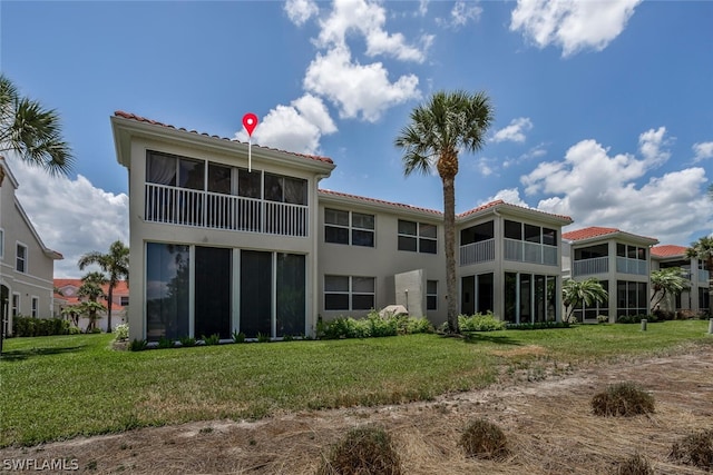 rear view of house featuring a yard