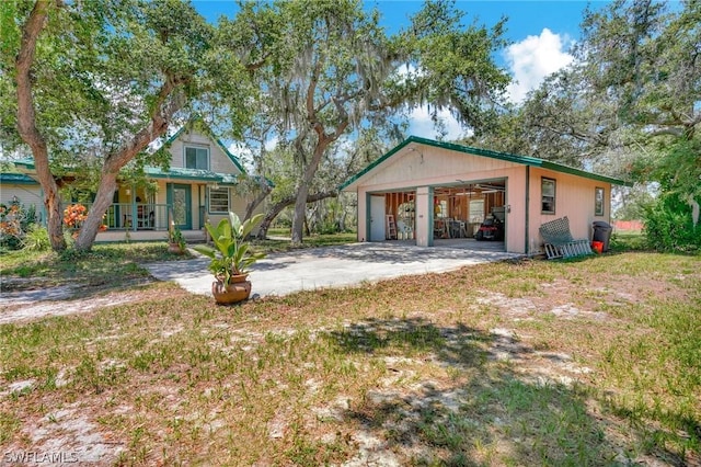 view of front facade with a porch, a garage, and a front lawn