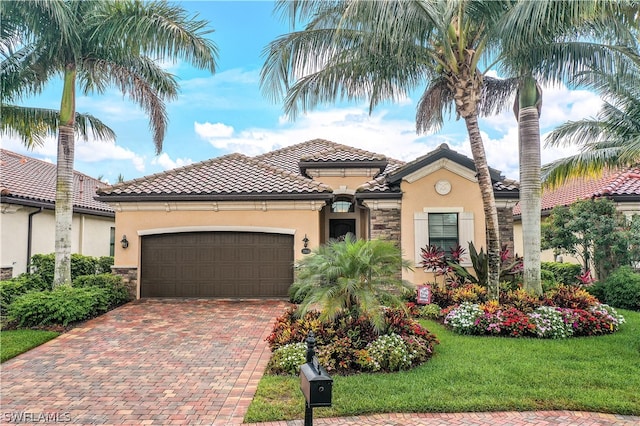 mediterranean / spanish home with a garage and a front lawn