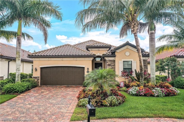 mediterranean / spanish home with a garage and a front yard