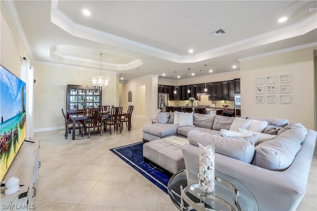 living room with a chandelier, light tile flooring, a raised ceiling, and crown molding