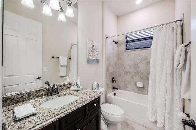 full bathroom with tile floors, oversized vanity, toilet, and shower / tub combo