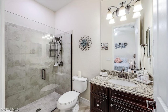 bathroom featuring a chandelier, vanity, toilet, and a shower with shower door