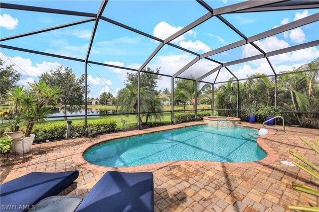 view of pool featuring a lanai, an in ground hot tub, and a patio area