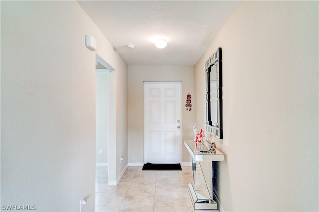 interior space featuring a textured ceiling and light tile patterned flooring