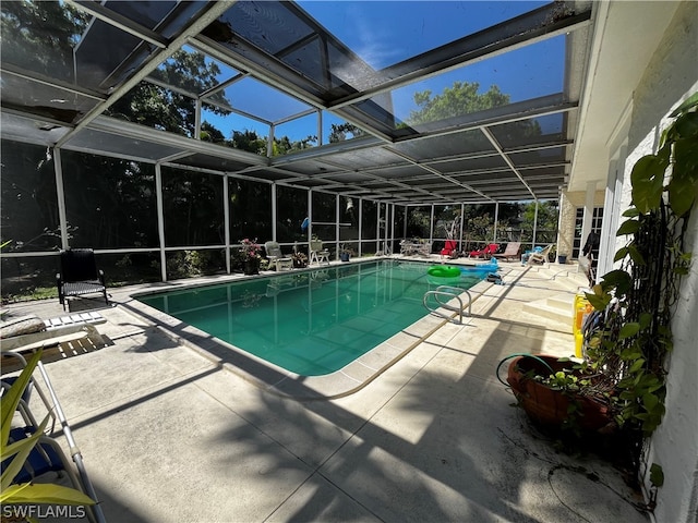 view of swimming pool with a lanai and a patio area