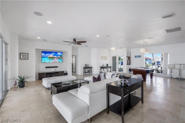 living room with ceiling fan and pool table