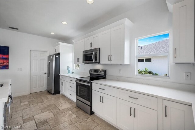 kitchen featuring white cabinetry and appliances with stainless steel finishes