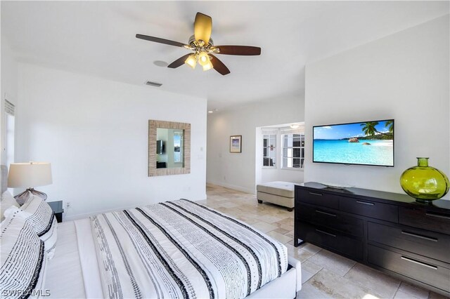 tiled bedroom with ceiling fan