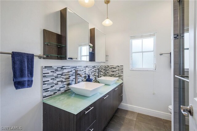 bathroom featuring backsplash, tile patterned floors, vanity, and toilet