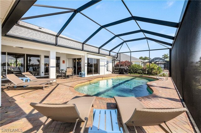 view of swimming pool with a lanai and a patio