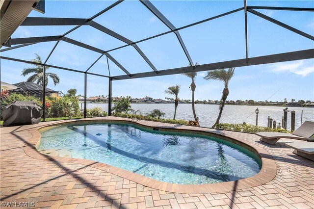 view of swimming pool with a lanai, area for grilling, a patio area, and a water view