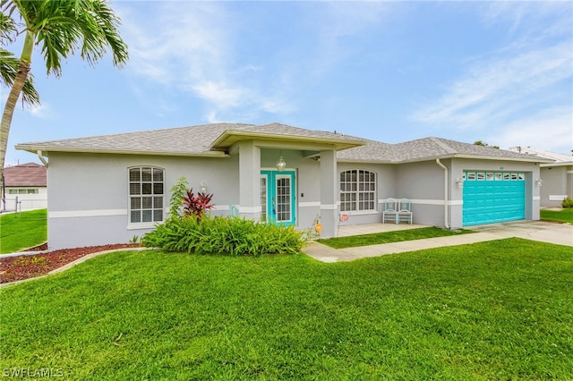 view of front of home with a front yard and a garage