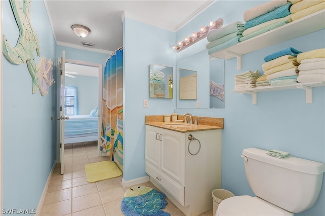 bathroom featuring toilet, vanity, tile patterned floors, and crown molding