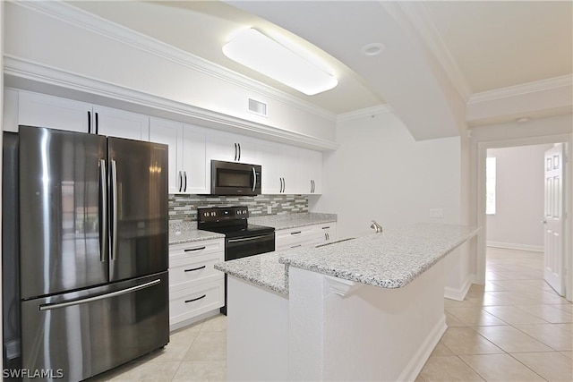 kitchen with light tile patterned flooring, white cabinetry, stainless steel appliances, a kitchen island with sink, and backsplash