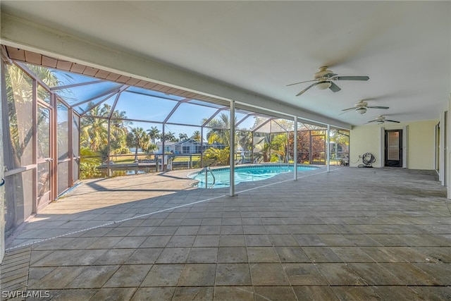 view of swimming pool featuring a lanai, a patio area, and ceiling fan