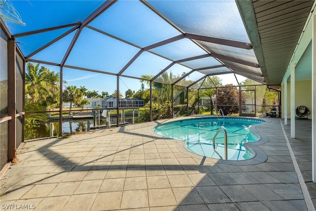 view of swimming pool featuring a lanai, a boat dock, a patio area, and a water view