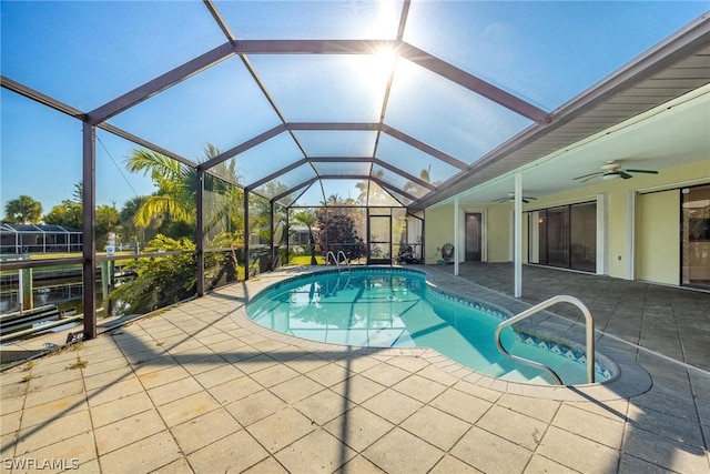 view of pool with a lanai, ceiling fan, and a patio