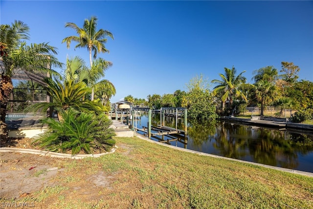 dock area featuring a yard and a water view