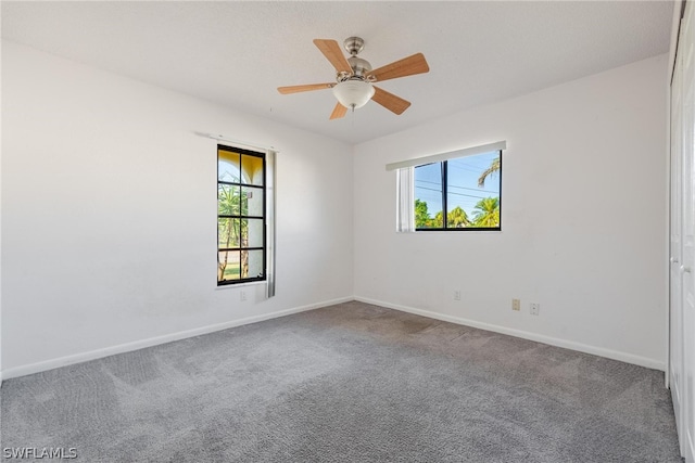 empty room with carpet flooring and ceiling fan