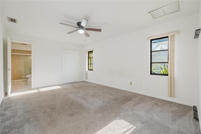 spare room featuring ceiling fan and carpet floors