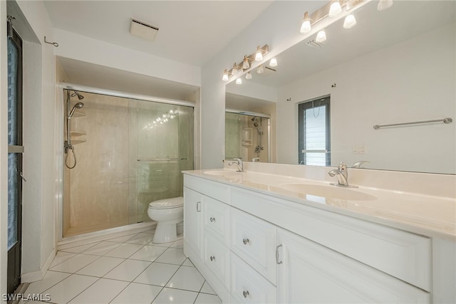 bathroom with toilet, vanity, tile patterned floors, and an enclosed shower