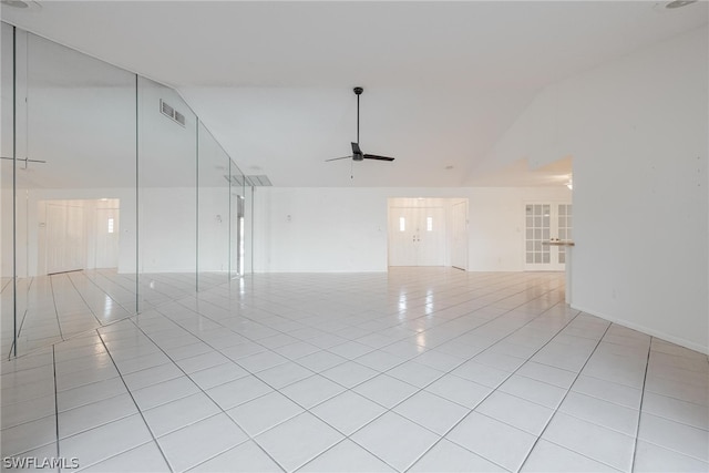 unfurnished room featuring ceiling fan, lofted ceiling, and light tile patterned flooring