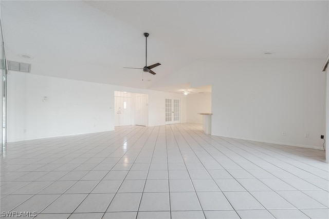 unfurnished room featuring ceiling fan, light tile patterned floors, and lofted ceiling