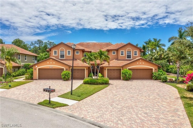 mediterranean / spanish house with a garage