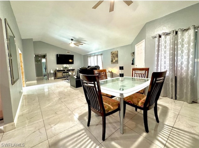 tiled dining room featuring ceiling fan and vaulted ceiling