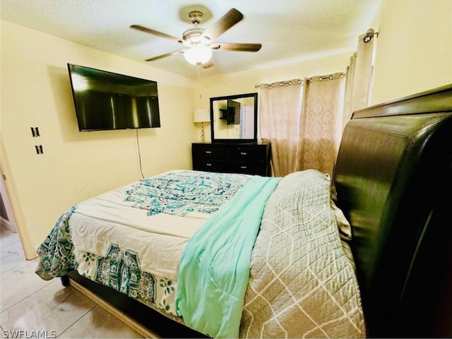 tiled bedroom with ceiling fan