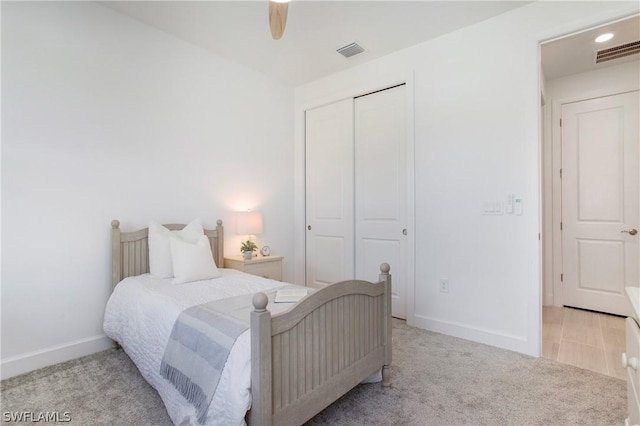 carpeted bedroom with a closet and ceiling fan