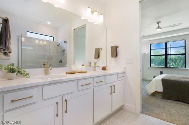 bathroom with ceiling fan, vanity, tile patterned flooring, and a shower with door