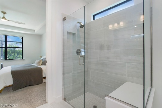 bathroom with ceiling fan and a shower with door