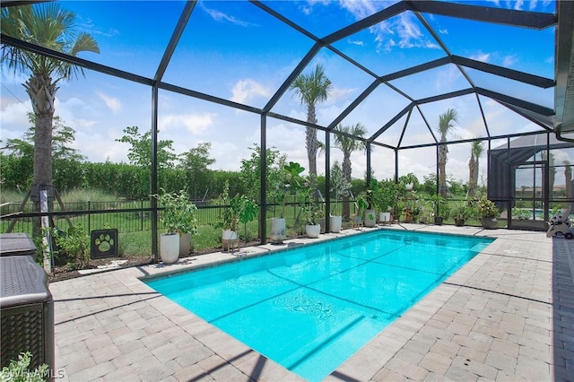 view of pool featuring a patio area, a fenced in pool, a lanai, and fence
