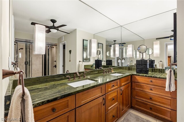 bathroom featuring tile patterned flooring, vanity, walk in shower, and a wealth of natural light