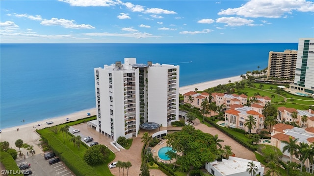 drone / aerial view featuring a water view and a beach view