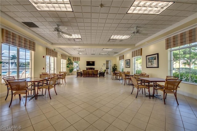 14573 Abaco Lakes Dr Unit 102, Fort Myers, FL 33908 - dining room featuring a ceiling fan, light tile patterned floors, plenty of natural light, a drop ceiling, and ornamental molding