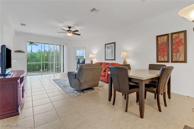 dining area with ceiling fan and light tile patterned floors