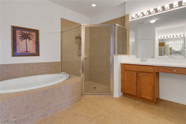 bathroom with tile patterned flooring, vanity, and separate shower and tub