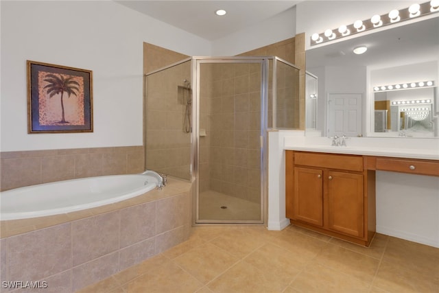 14573 Abaco Lakes Dr Unit 102, Fort Myers, FL 33908 - full bathroom featuring tile patterned floors, a stall shower, a garden tub, and vanity
